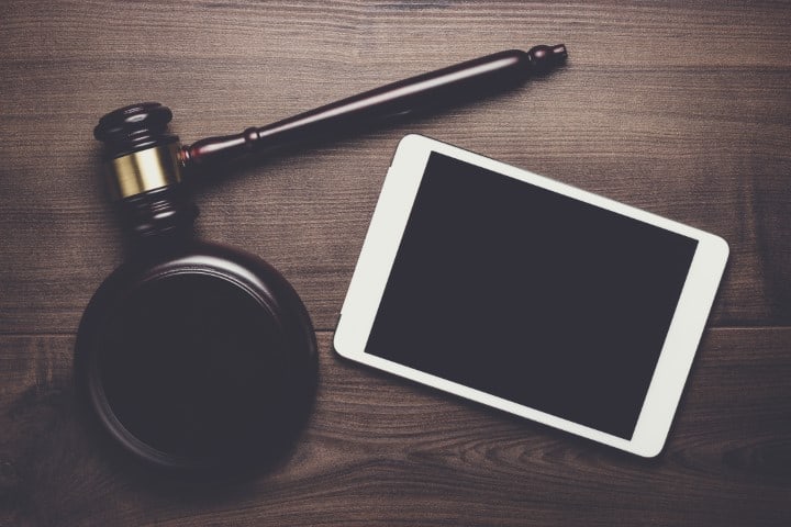 Judge Gavel And Tablet Computer On Brown Wooden Background